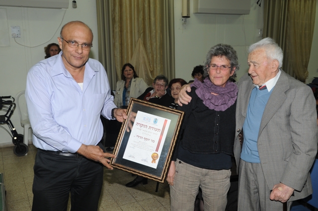 Mr. Eitan Cohen, administrative director, grants a Certificate of Recognition to the daughter of the first administrator, the late Mr. Joseph Hardy 